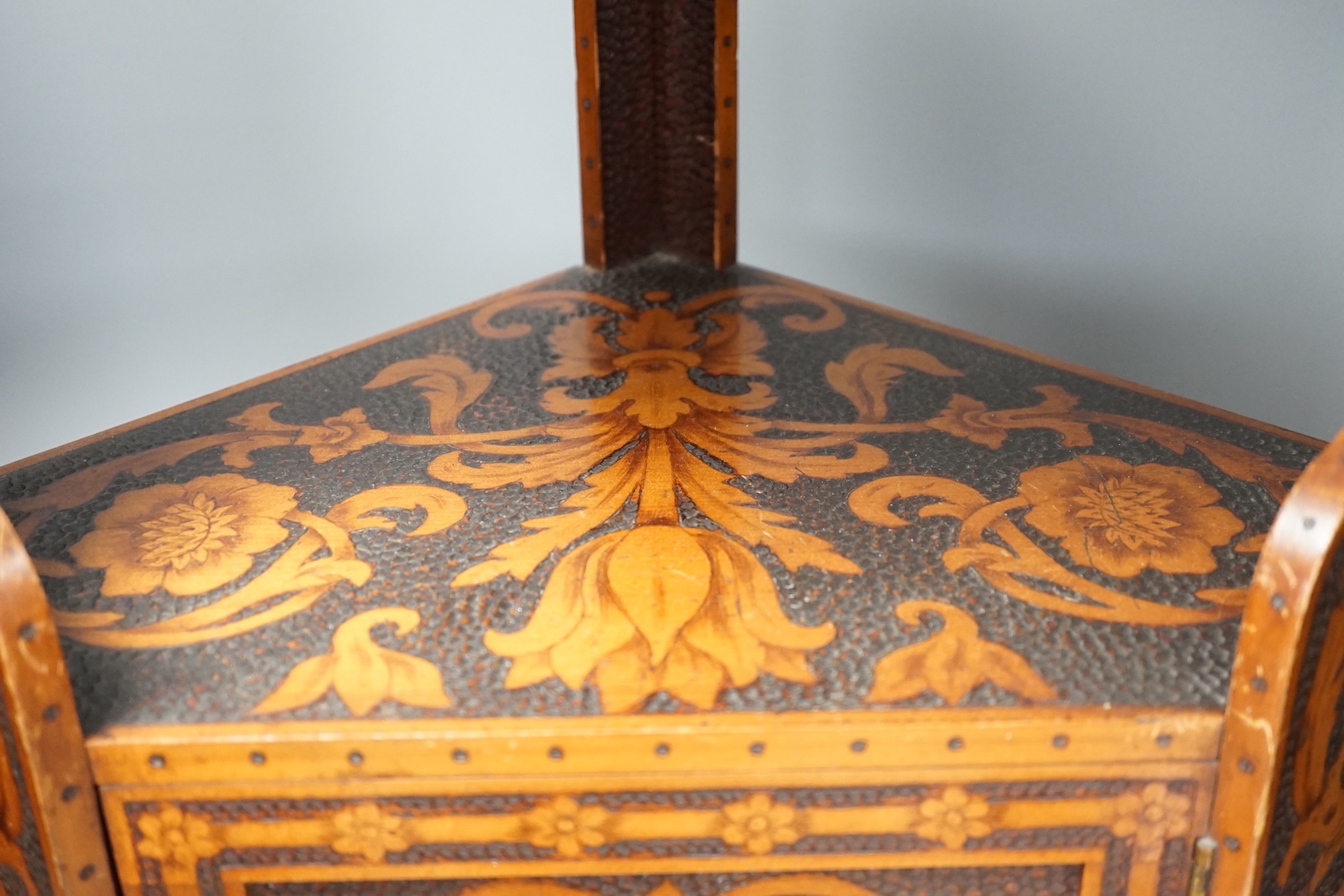 A pokerwork hanging corner cabinet, 58cm
